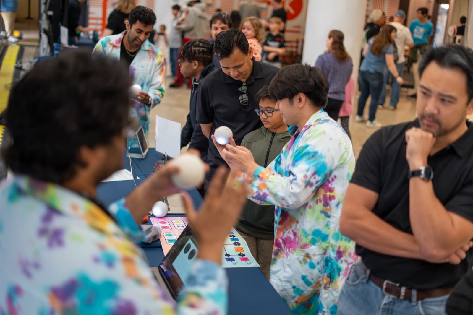 Teens and families at the quantum booth
