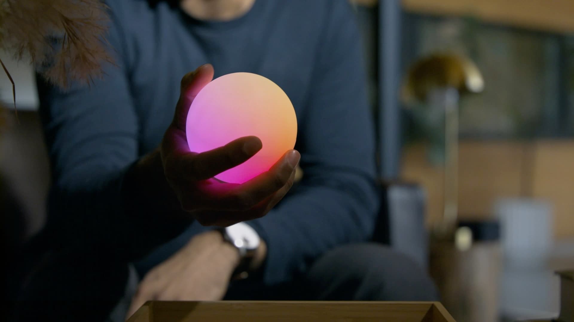 Qubi held in hand, glowing